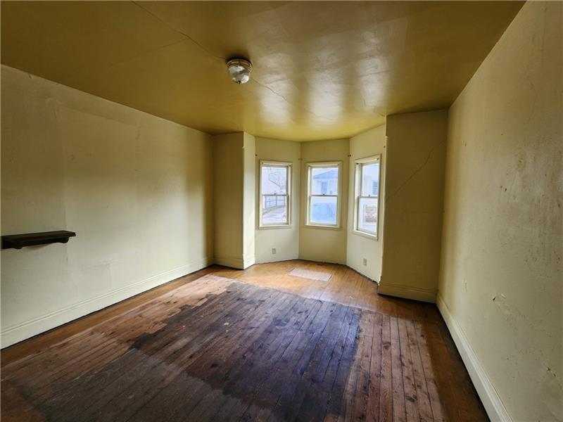 524 Cross Street Rochester, PA 15074 - Photo 8 of 20 an empty room with wooden floor and windows