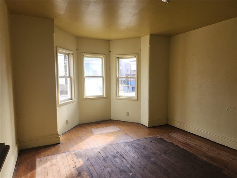524 Cross Street Rochester, PA 15074 - Photo 9 of 20 an empty room with wooden floor and windows