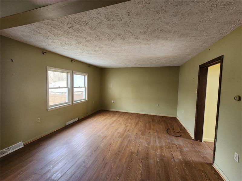 524 Cross Street Rochester, PA 15074 - Photo 10 of 20 an empty room with wooden floor and windows