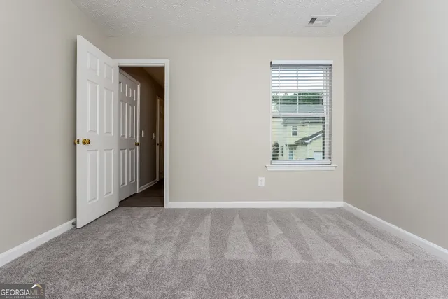 a bathroom with a sink a toilet a mirror and window