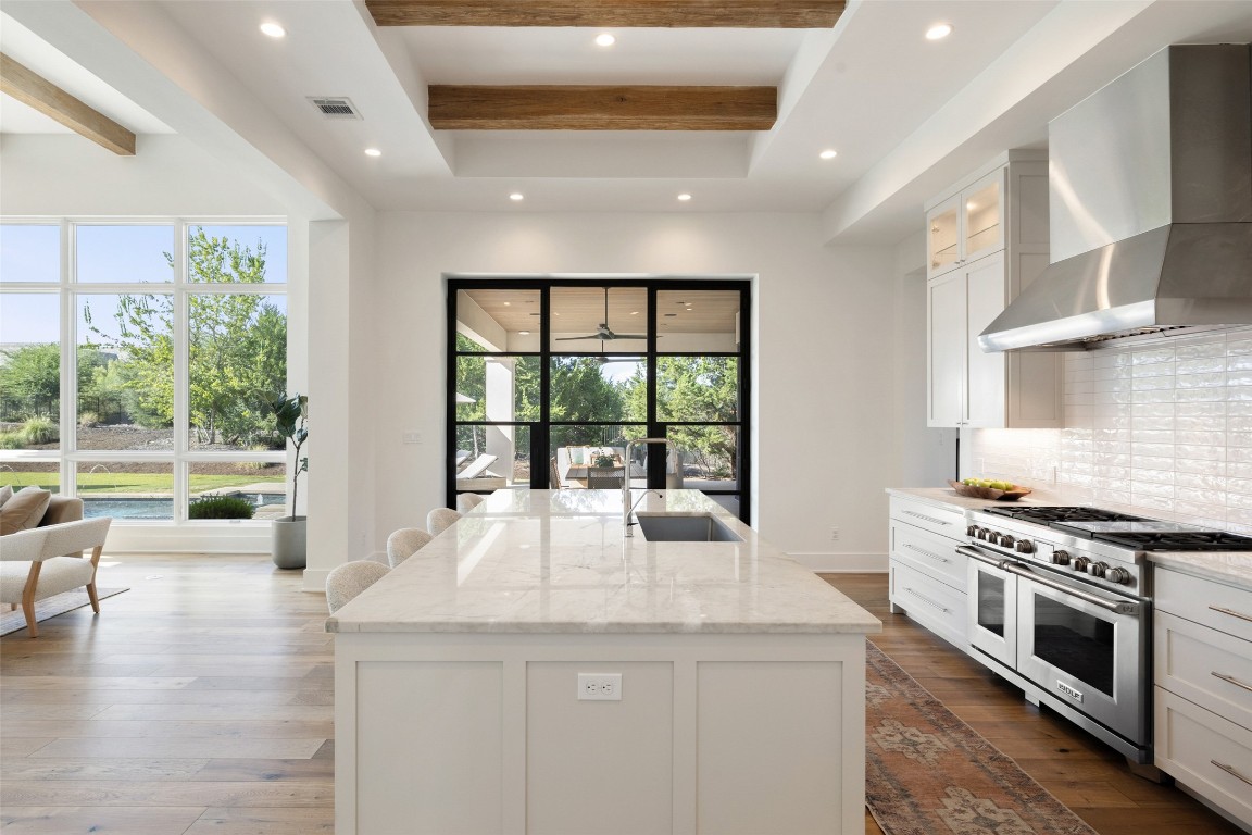567 Delayne Drive Austin, TX 78737 - Photo 13 of 40 a kitchen with stainless steel appliances granite countertop a stove and a large window