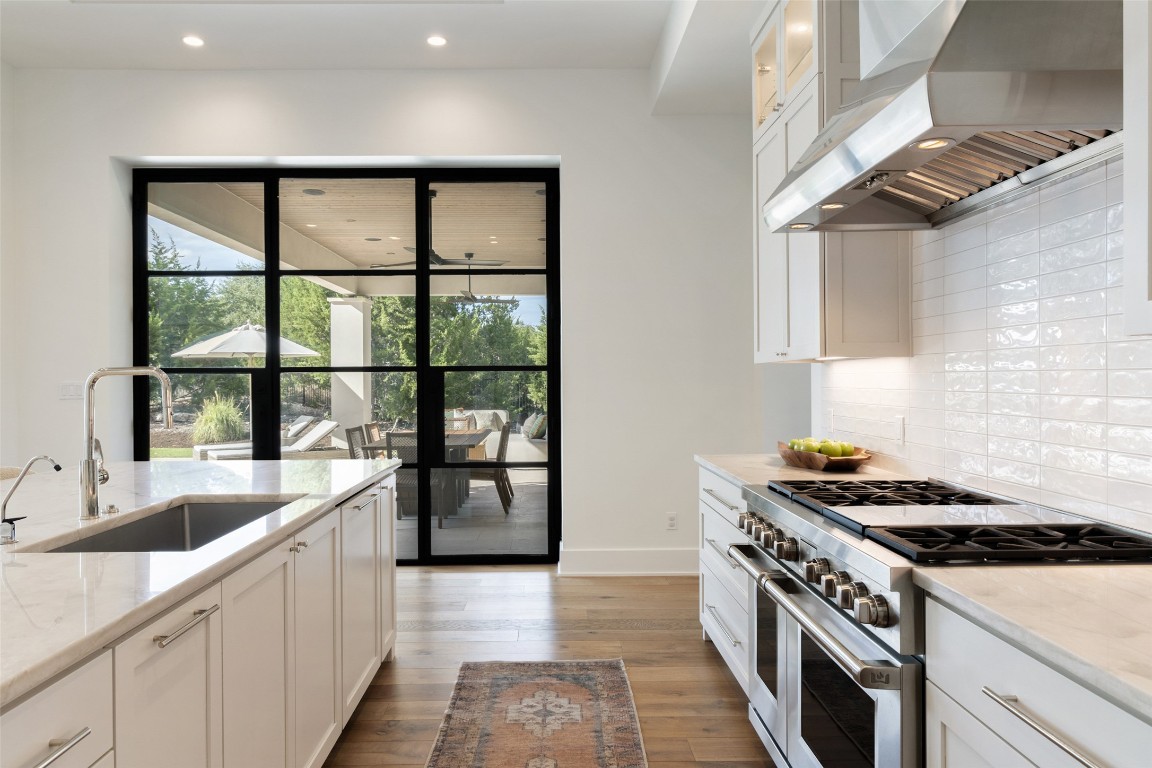 567 Delayne Drive Austin, TX 78737 - Photo 14 of 40 a kitchen with a stove and a sink