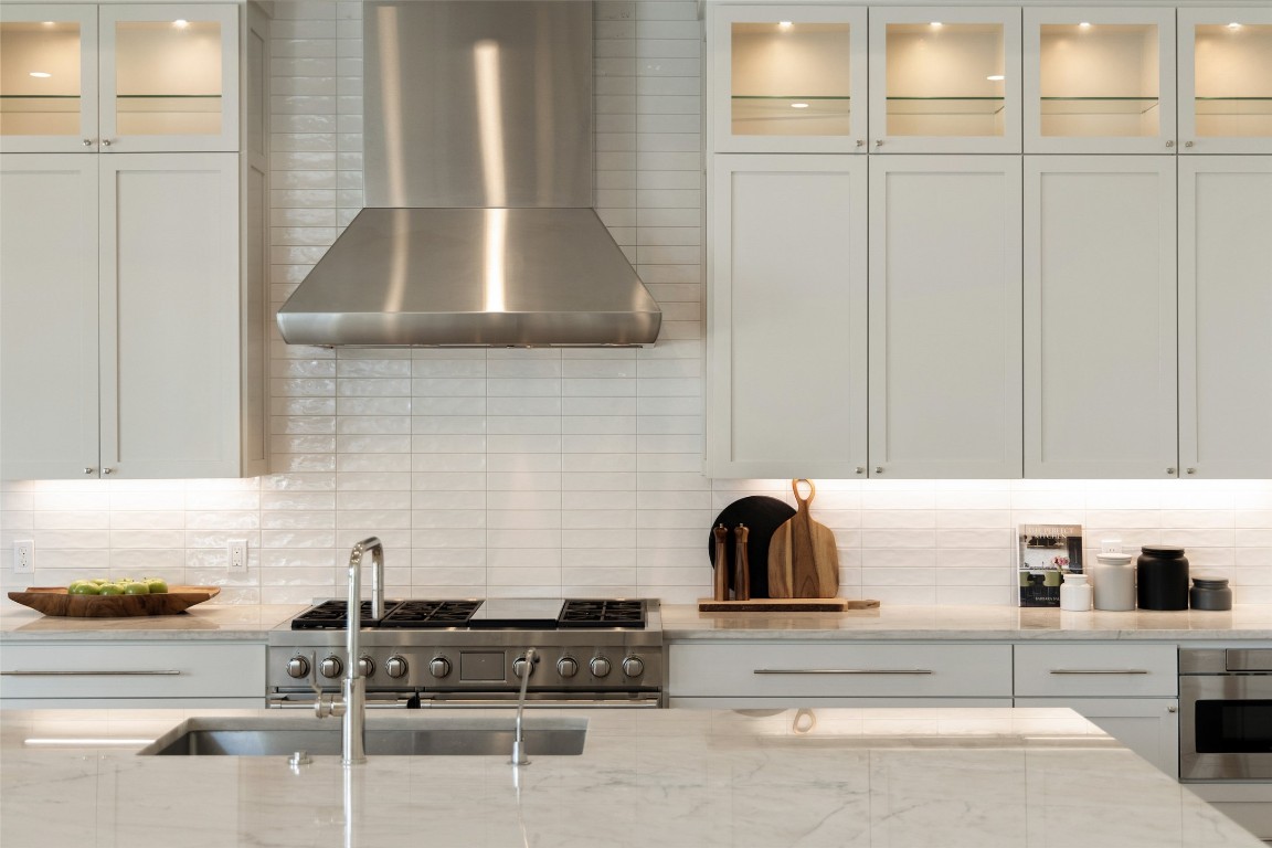 567 Delayne Drive Austin, TX 78737 - Photo 17 of 40 a kitchen with granite countertop white cabinets and white appliances