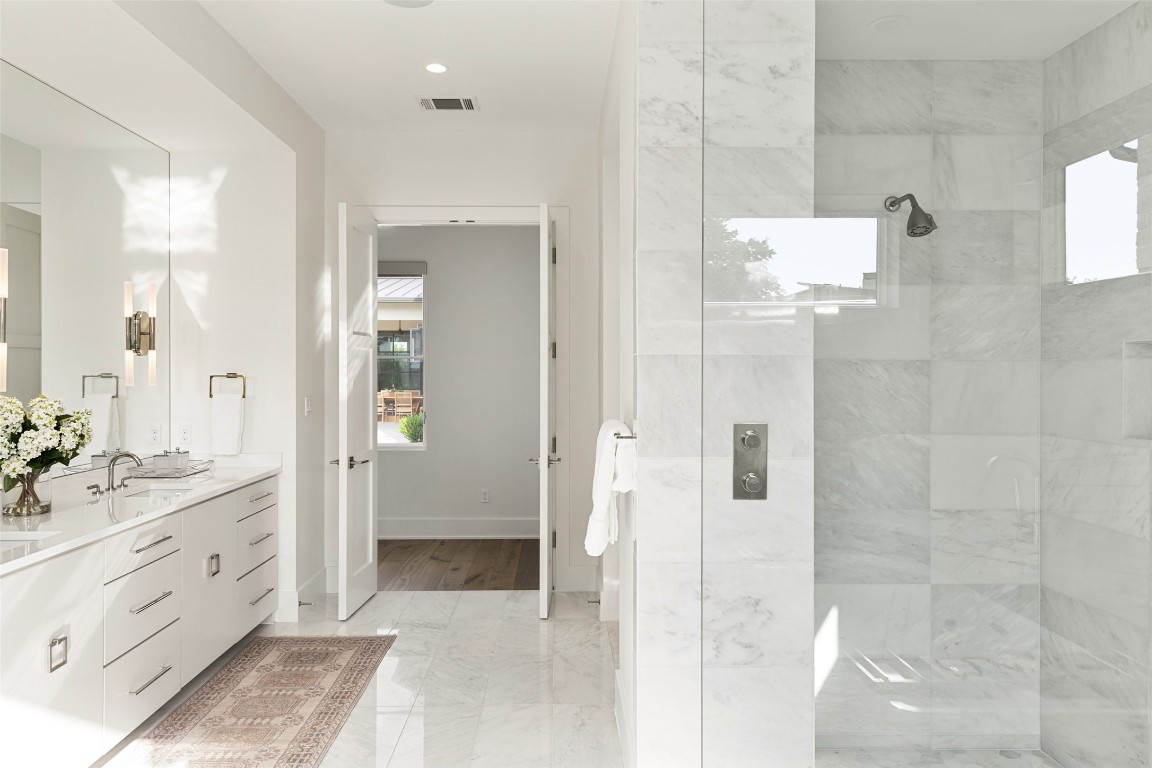 567 Delayne Drive Austin, TX 78737 - Photo 25 of 40 a bathroom with a double vanity sink a mirror and a shower