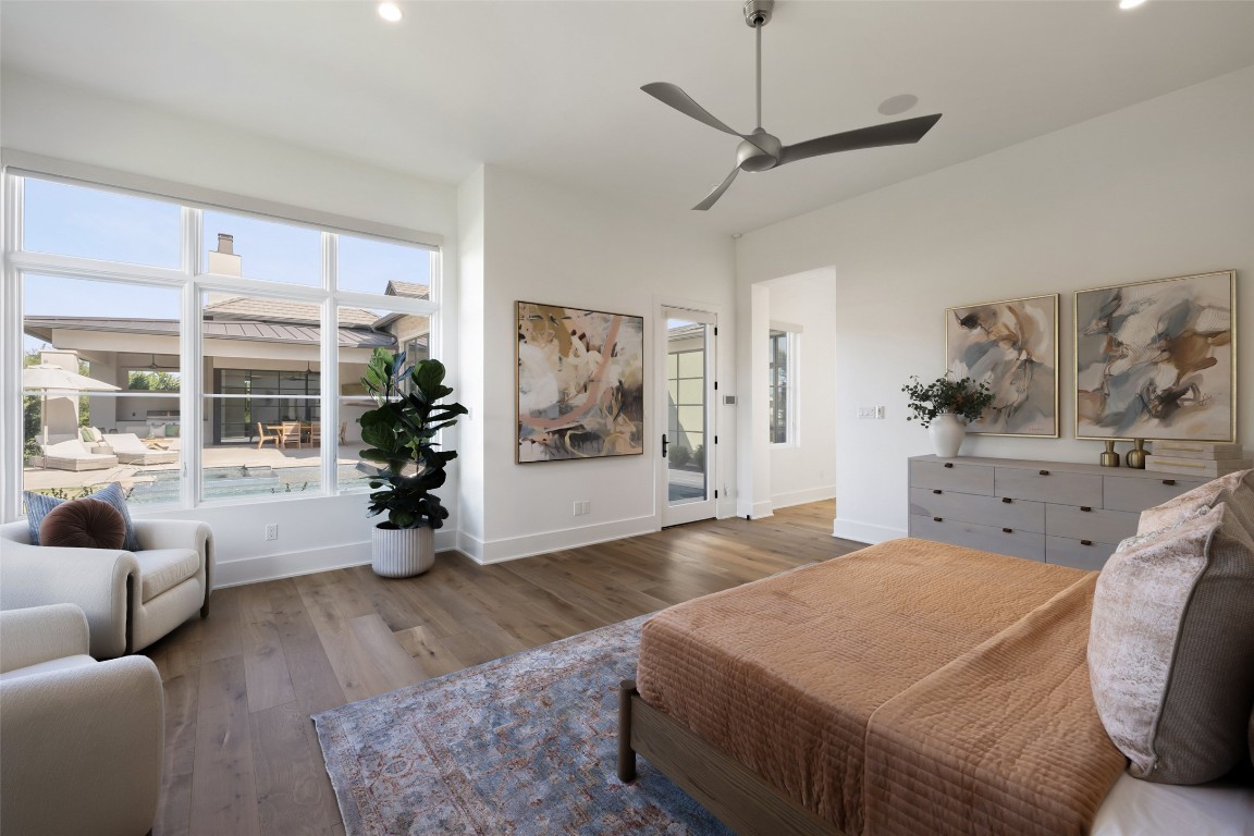 567 Delayne Drive Austin, TX 78737 - Photo 27 of 40 a spacious bedroom with a bed a couch and a window