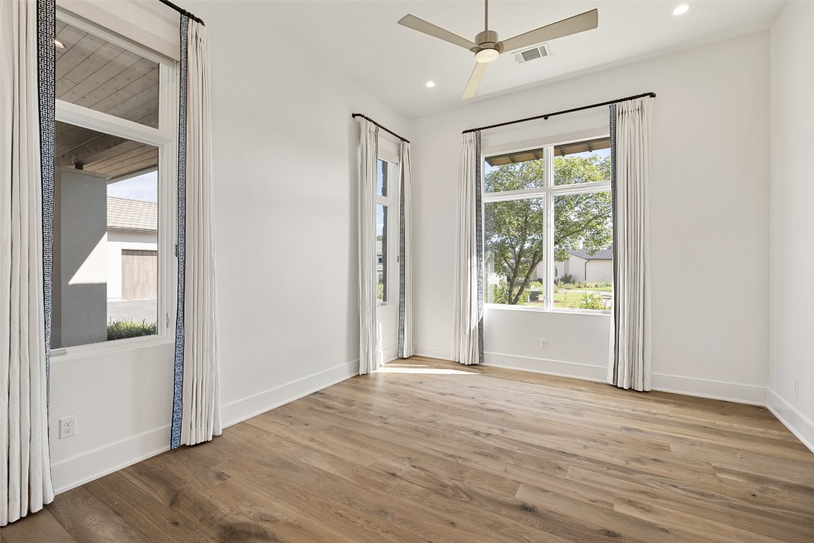 567 Delayne Drive Austin, TX 78737 - Photo 31 of 40 an empty room with wooden floor and windows