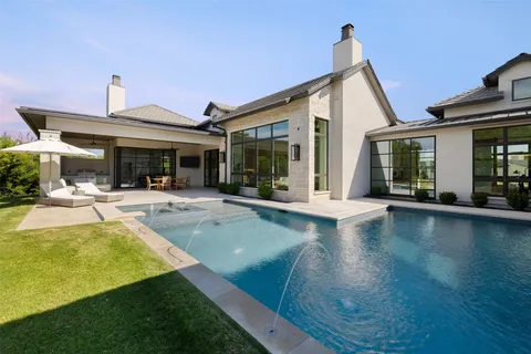 a view of a house with swimming pool and a porch with furniture