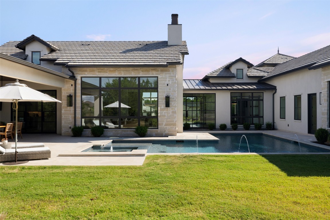 567 Delayne Drive Austin, TX 78737 - Photo 40 of 40 a view of a house with swimming pool and a porch with furniture