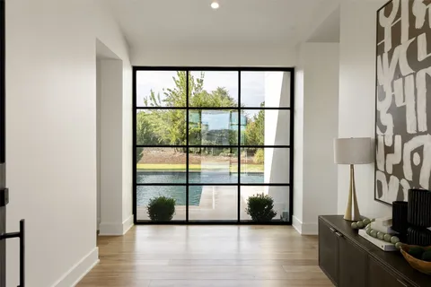 a view of a room with wooden floor and windows