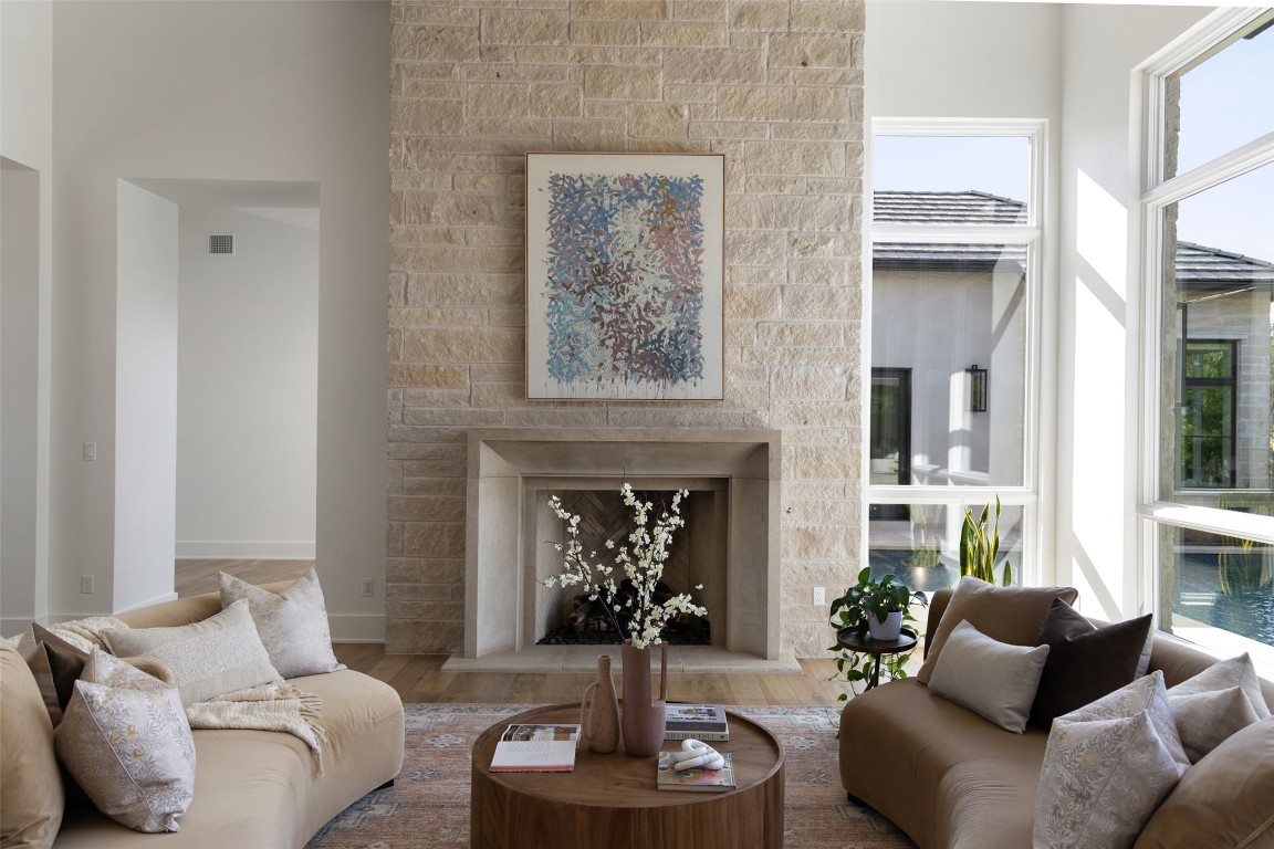 567 Delayne Drive Austin, TX 78737 - Photo 9 of 40 a living room with furniture potted plant and a fireplace