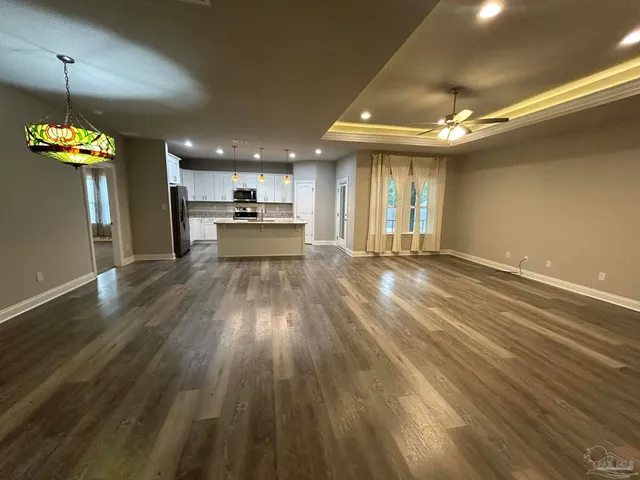 a view of a kitchen with a sink wooden floor and a window