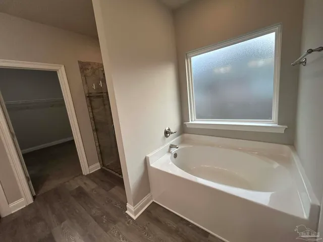 a white bath tub sitting next to a white sink