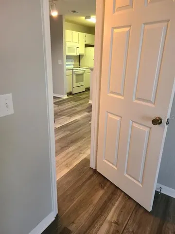a view of a hallway with wooden floor