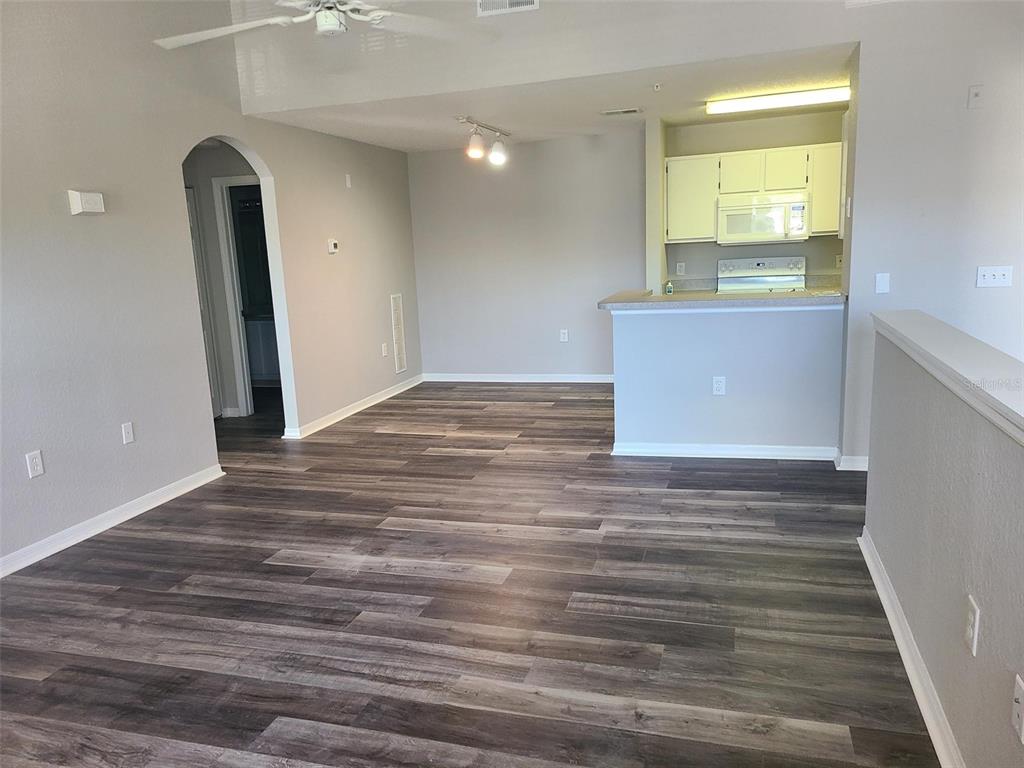 8933 Manor Loop, Unit 202 Lakewood Ranch, FL 34202 - Photo 3 of 17 a view of a room with wooden floor and entryway