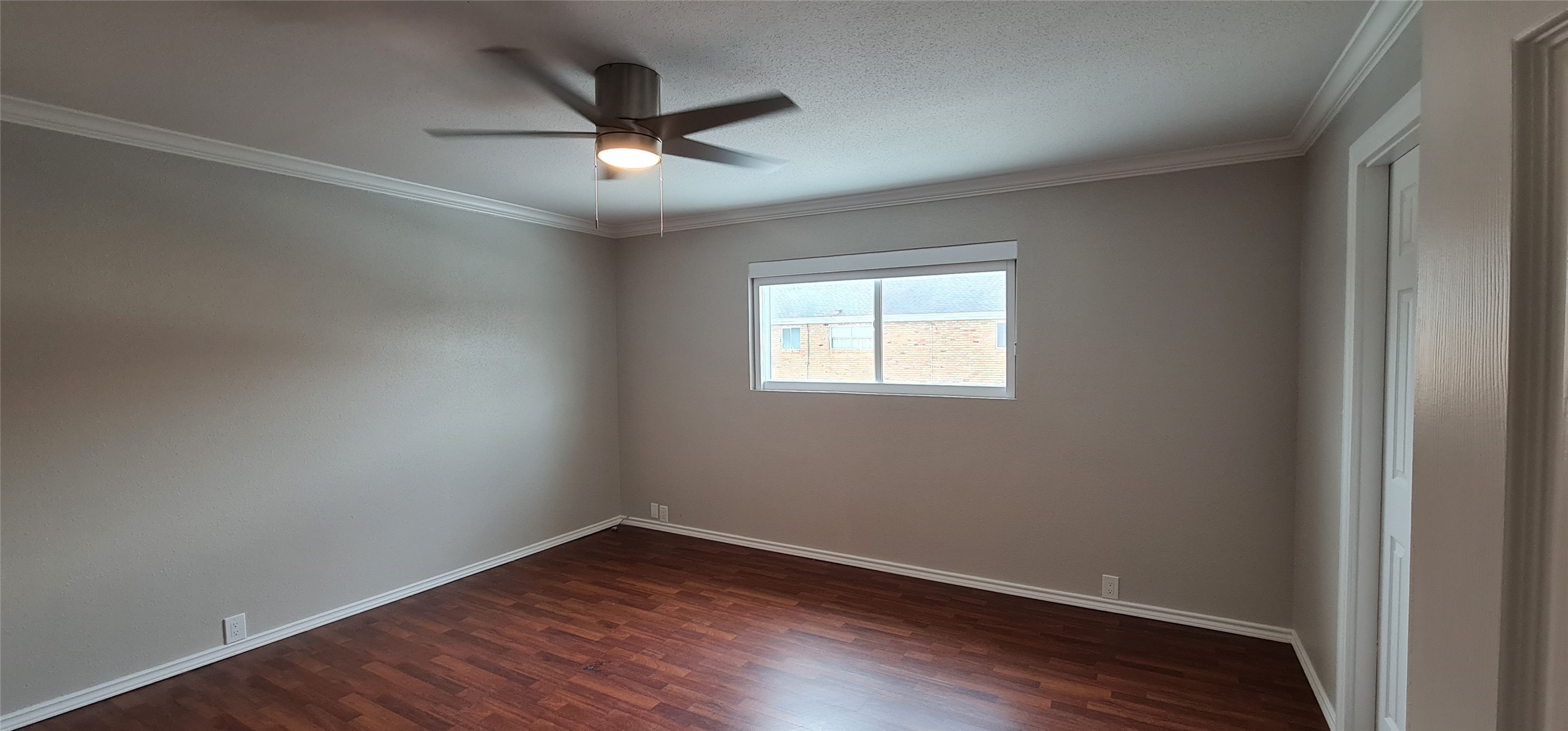 2201 Fountain View Drive, Unit 24 Houston, TX 77057 - Photo 5 of 9 an empty room with wooden floor ceiling fan and windows