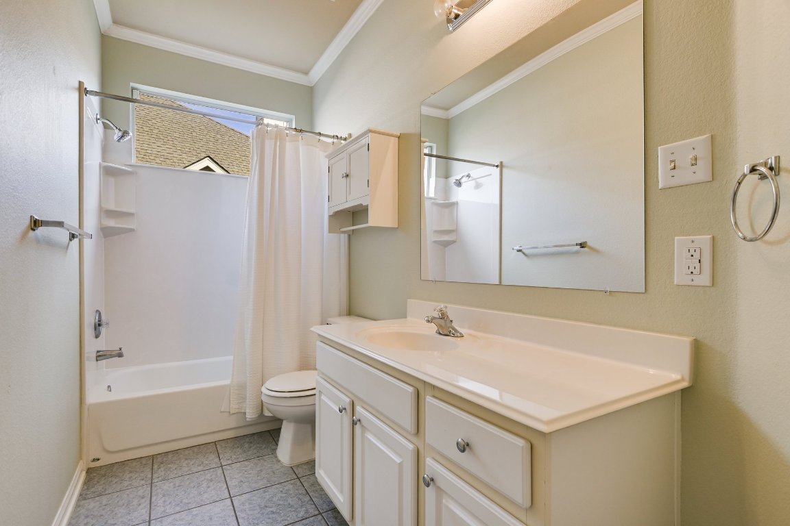 11705 Gold Run Cove Manor, TX 78653 - Photo 11 of 20 a bathroom with a sink a toilet and a large mirror