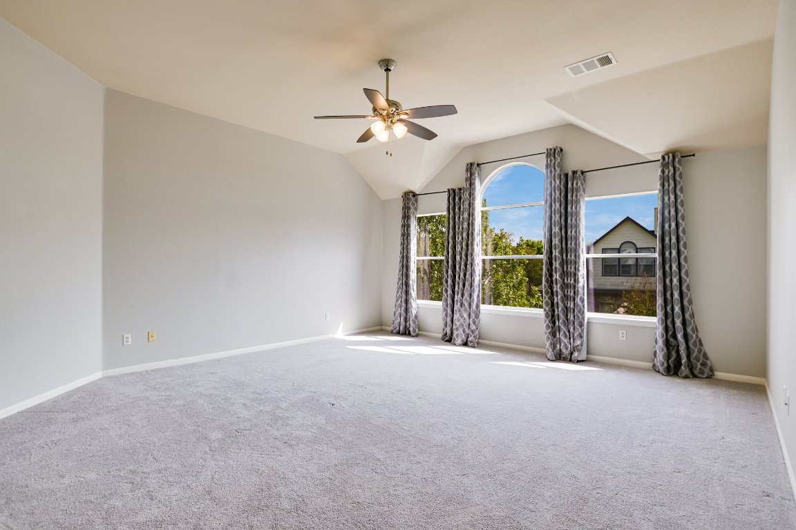 11705 Gold Run Cove Manor, TX 78653 - Photo 13 of 20 a view of a big room with chandelier fan and windows
