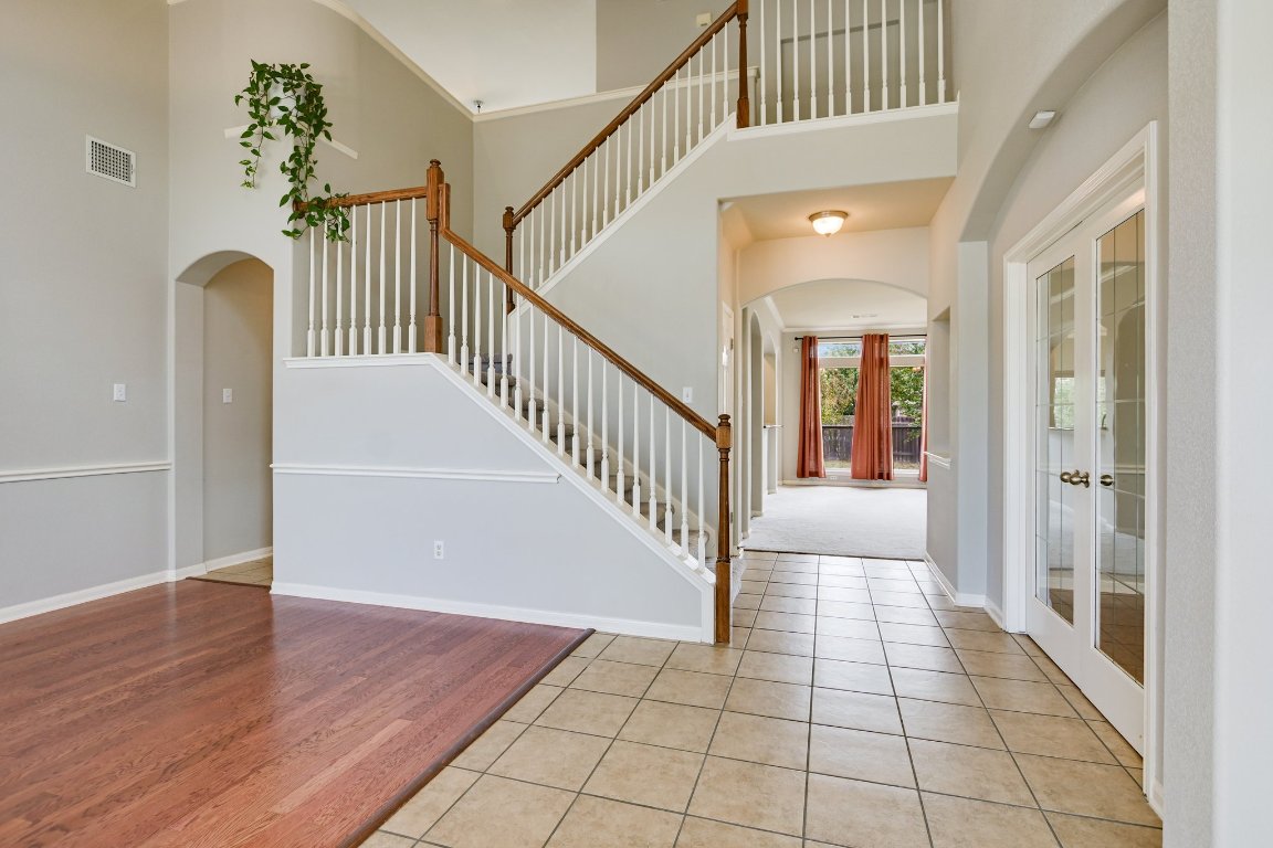 11705 Gold Run Cove Manor, TX 78653 - Photo 2 of 20 a view of a hallway with entryway and wooden floor