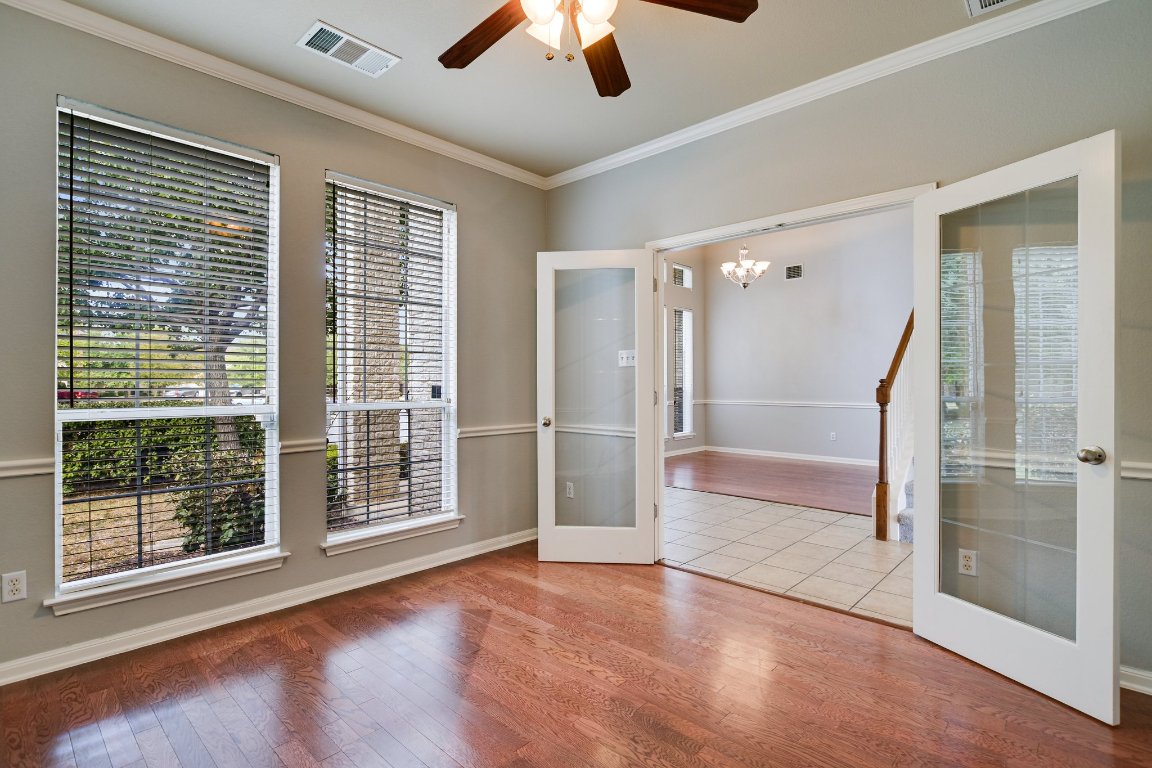11705 Gold Run Cove Manor, TX 78653 - Photo 4 of 20 a view of an empty room with a window and wooden floor