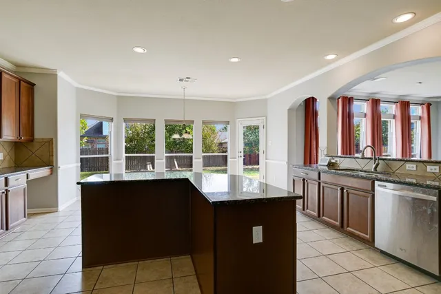 a kitchen with a sink and large window