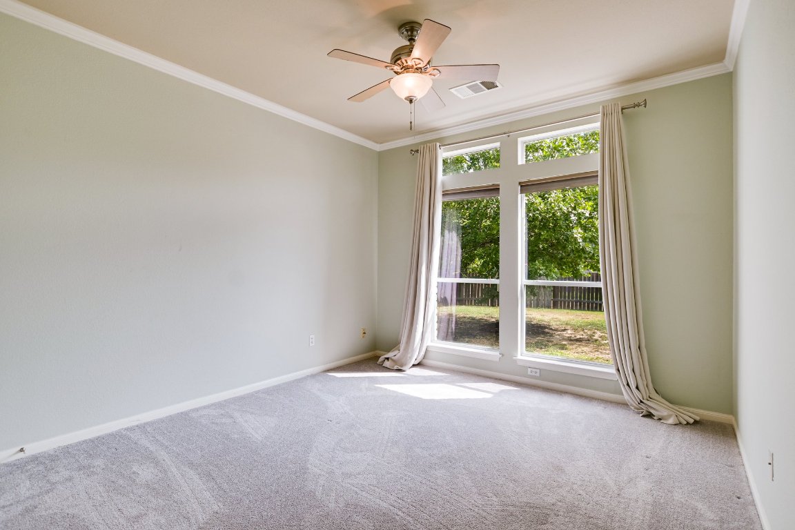 11705 Gold Run Cove Manor, TX 78653 - Photo 10 of 20 a view of a livingroom with a ceiling fan and window
