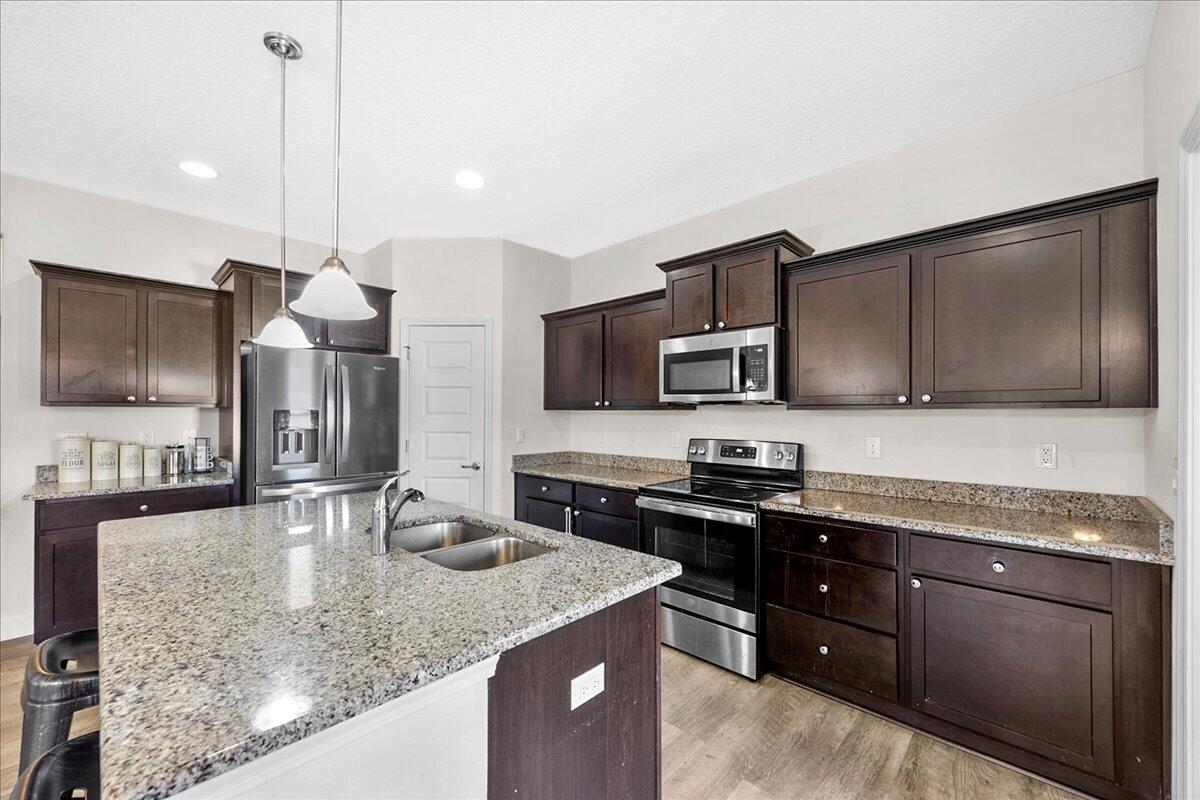 3030 Crown Creek Circle Crestview, FL 32539 - Photo 12 of 35 a kitchen with stainless steel appliances granite countertop a sink a stove and microwave