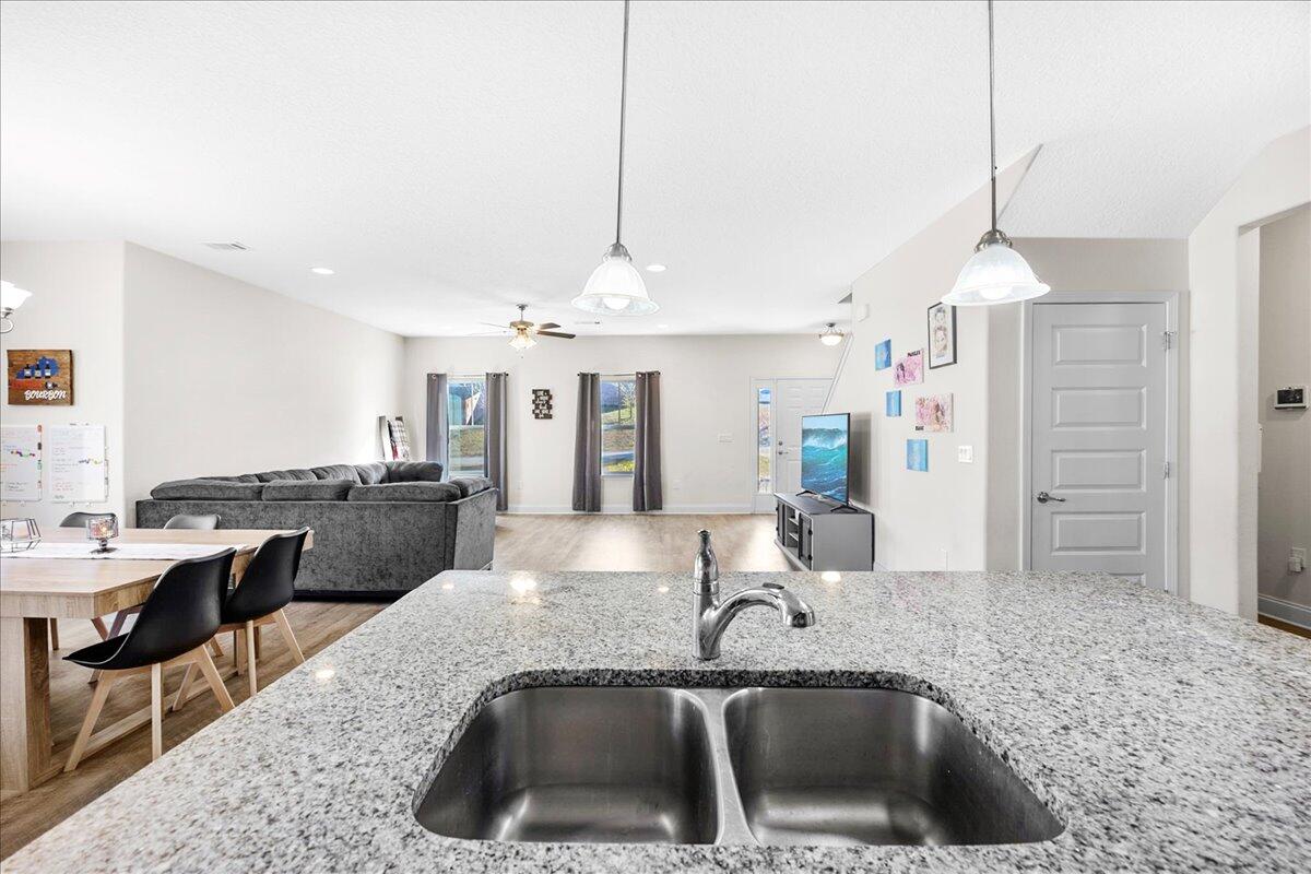 3030 Crown Creek Circle Crestview, FL 32539 - Photo 13 of 35 a kitchen with a sink a counter and chairs