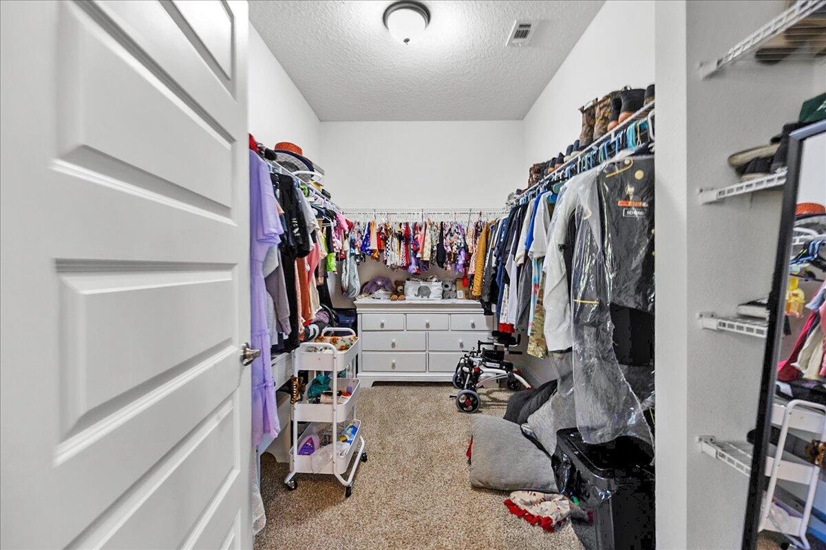 3030 Crown Creek Circle Crestview, FL 32539 - Photo 17 of 35 a view of walk in closet with clothes and shoes