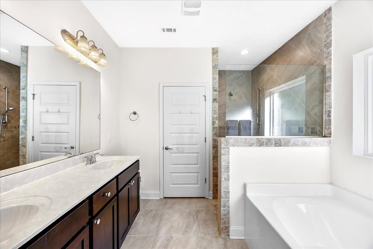 3030 Crown Creek Circle Crestview, FL 32539 - Photo 18 of 35 a bathroom with a tub sink and mirror