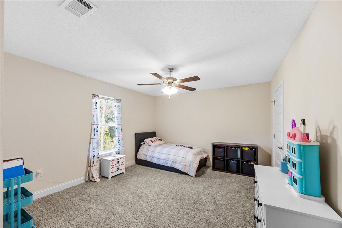 3030 Crown Creek Circle Crestview, FL 32539 - Photo 24 of 35 a bedroom with furniture and a chandelier