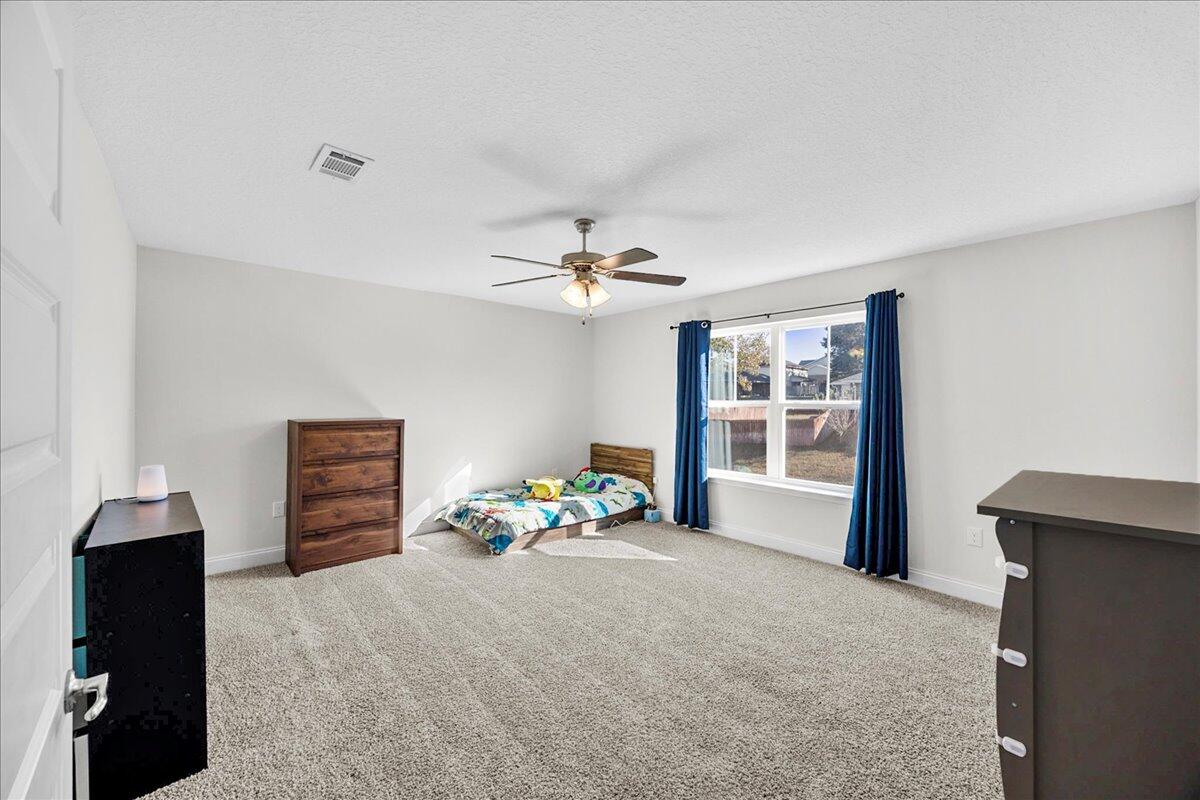 3030 Crown Creek Circle Crestview, FL 32539 - Photo 27 of 35 a bedroom with furniture and a window