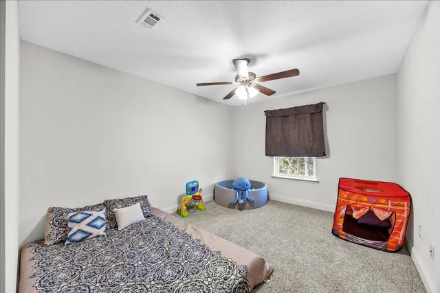 a bed room with a bed and a chandelier