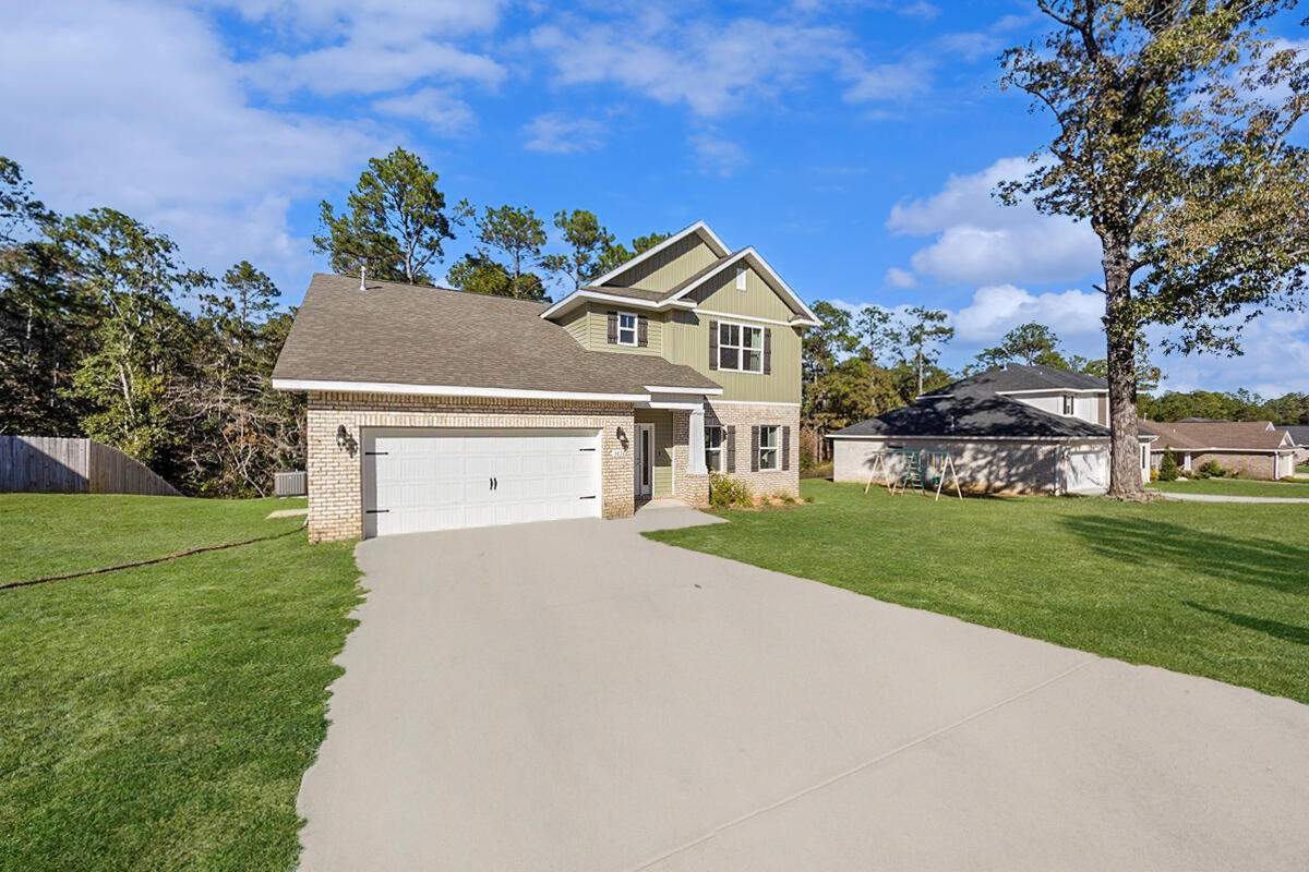 3030 Crown Creek Circle Crestview, FL 32539 - Photo 3 of 35 a front view of a house with a yard and garage
