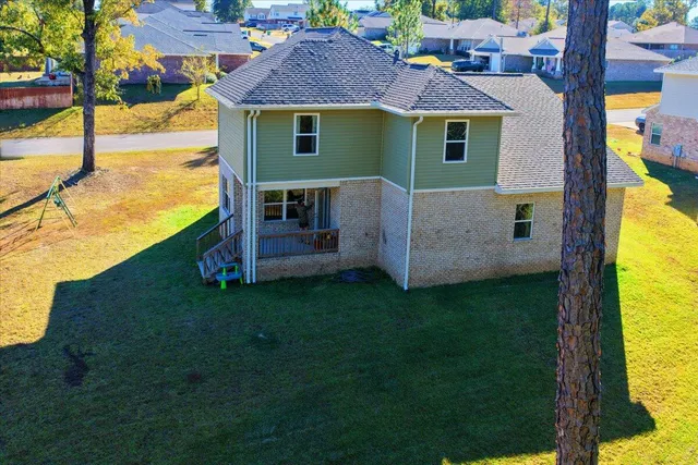 an aerial view of a house with swimming pool garden and patio