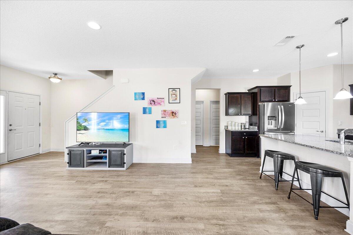 3030 Crown Creek Circle Crestview, FL 32539 - Photo 6 of 35 a living room with stainless steel appliances furniture and a flat screen tv
