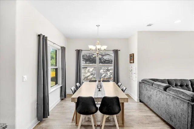 a dining room with furniture and window