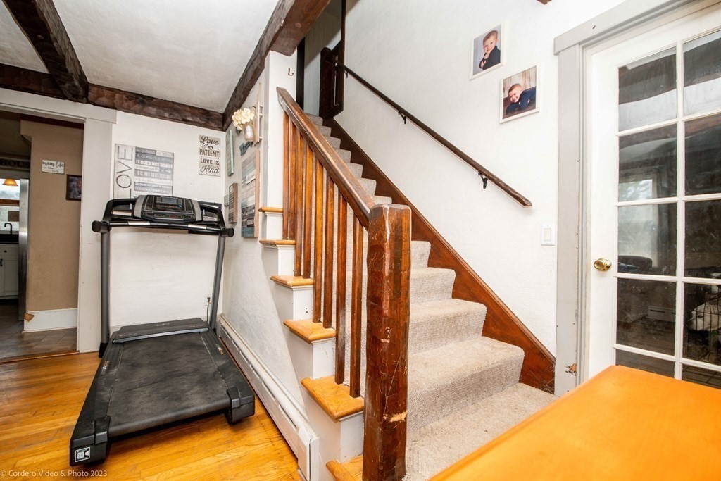 210 Hathaway Road Acushnet, MA 02743 - Photo 17 of 34 a view of a livingroom with wooden floor and stairs