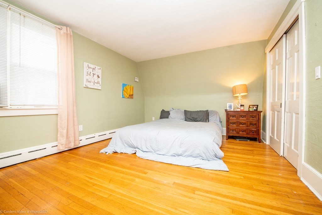 210 Hathaway Road Acushnet, MA 02743 - Photo 19 of 34 a bedroom with a bed and a large window