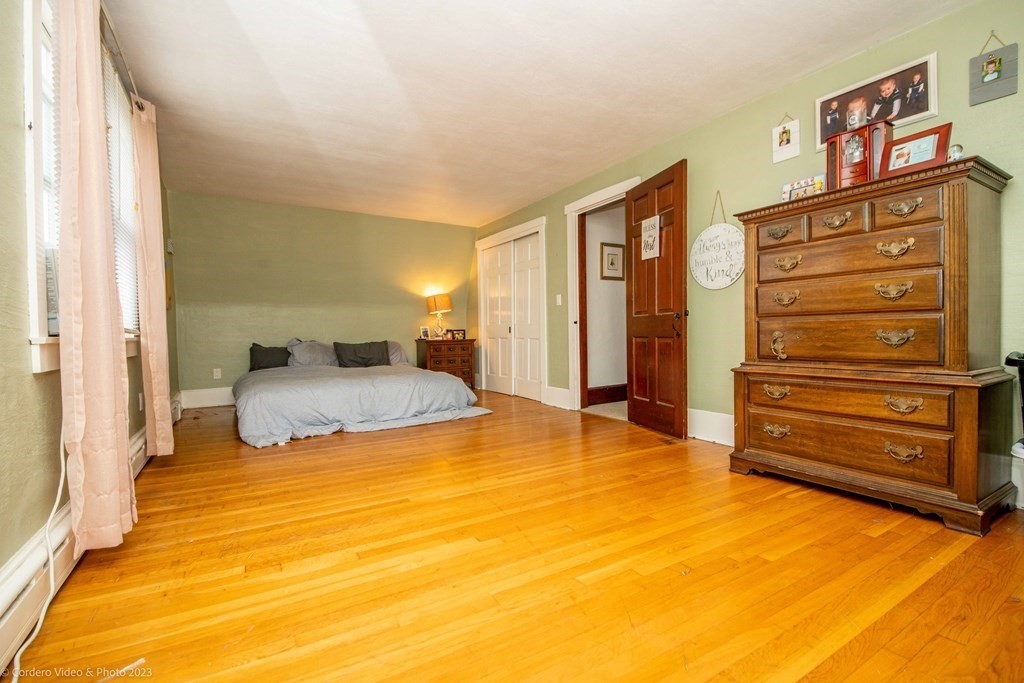 210 Hathaway Road Acushnet, MA 02743 - Photo 22 of 34 a bedroom with a bed and cabinets