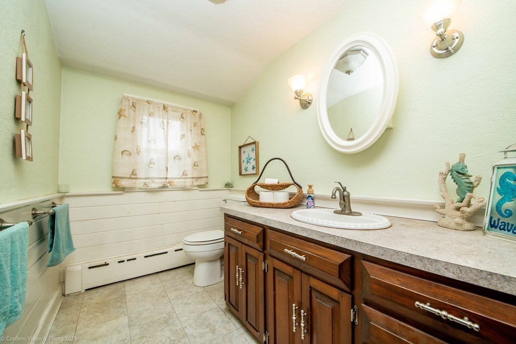 210 Hathaway Road Acushnet, MA 02743 - Photo 28 of 34 a bathroom with a granite countertop sink a mirror and a