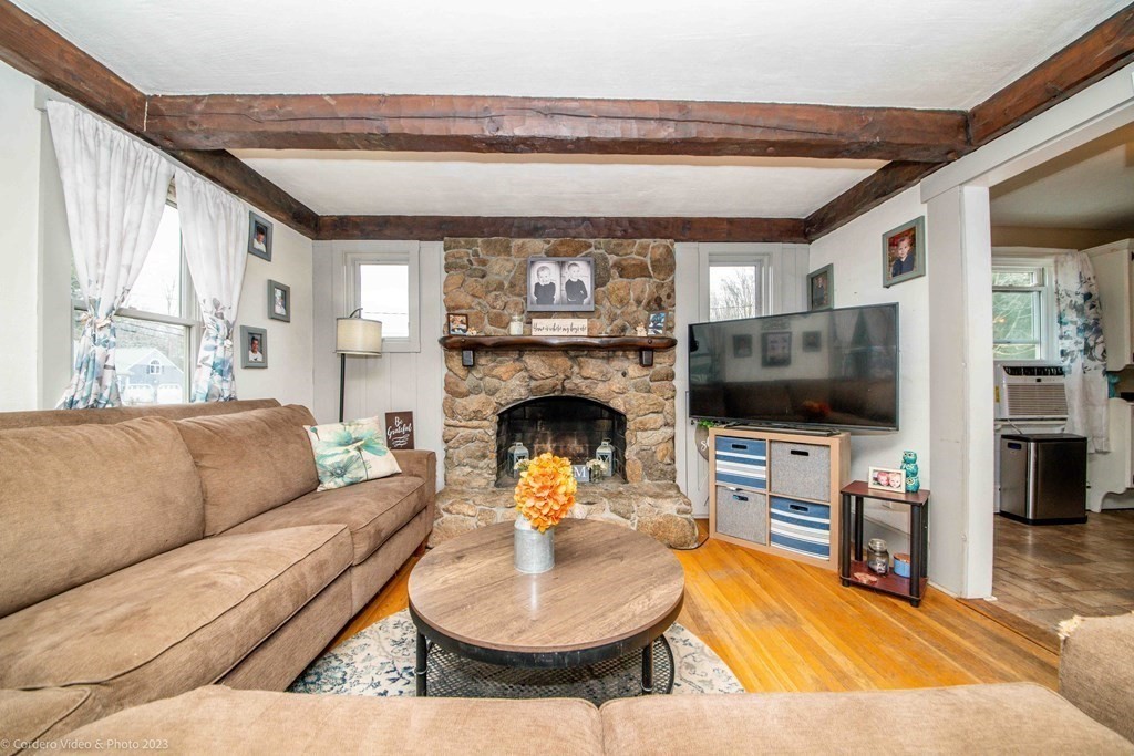 210 Hathaway Road Acushnet, MA 02743 - Photo 3 of 34 a living room with furniture a flat screen tv and a fireplace