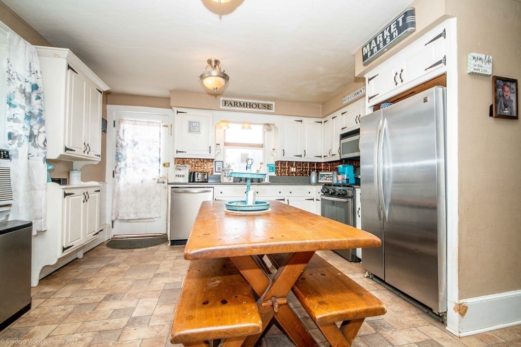 210 Hathaway Road Acushnet, MA 02743 - Photo 8 of 34 a kitchen with stainless steel appliances granite countertop a refrigerator and a stove top oven