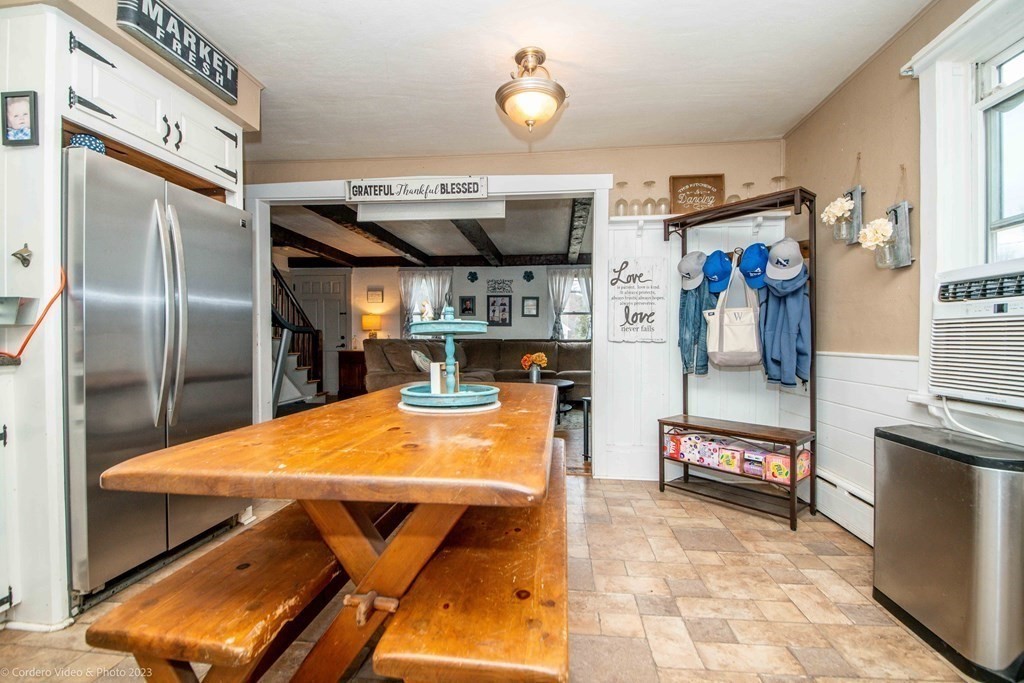 210 Hathaway Road Acushnet, MA 02743 - Photo 9 of 34 a view of a kitchen with stainless steel appliances dining table and a refrigerator