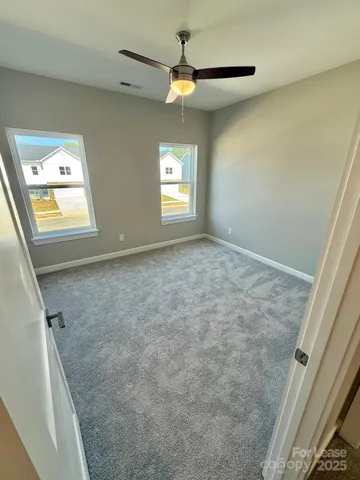 a view of an empty room and a window