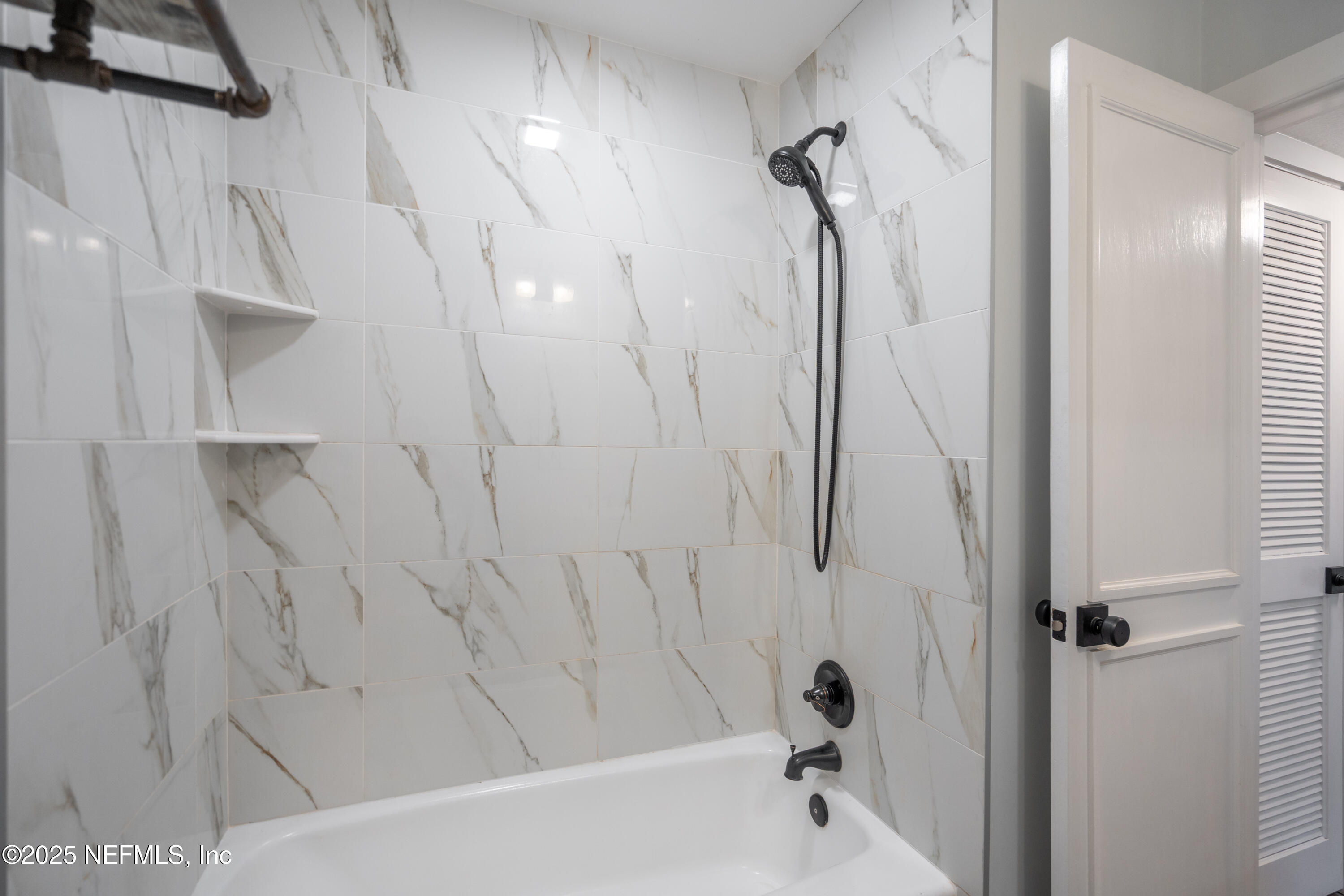 22 Comares Avenue, Unit 4A St. Augustine, FL 32080 - Photo 14 of 36 a bathroom with a shower