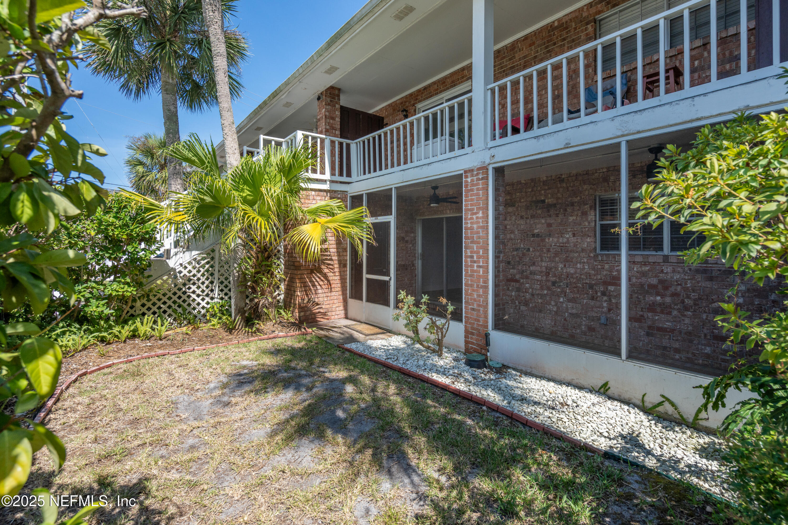 22 Comares Avenue, Unit 4A St. Augustine, FL 32080 - Photo 25 of 36 a view of a house with a small yard and plants