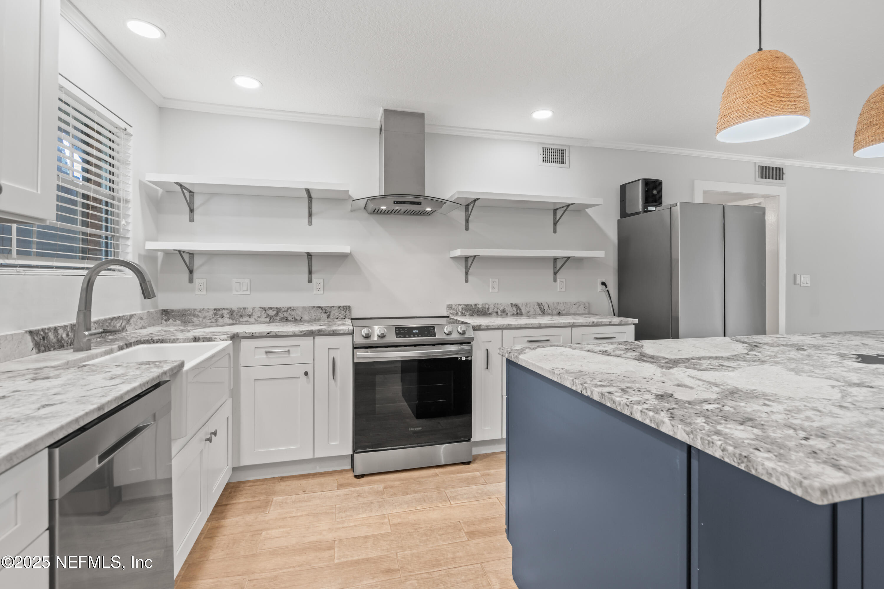 22 Comares Avenue, Unit 4A St. Augustine, FL 32080 - Photo 5 of 36 a kitchen with stainless steel appliances granite countertop a sink stove and refrigerator