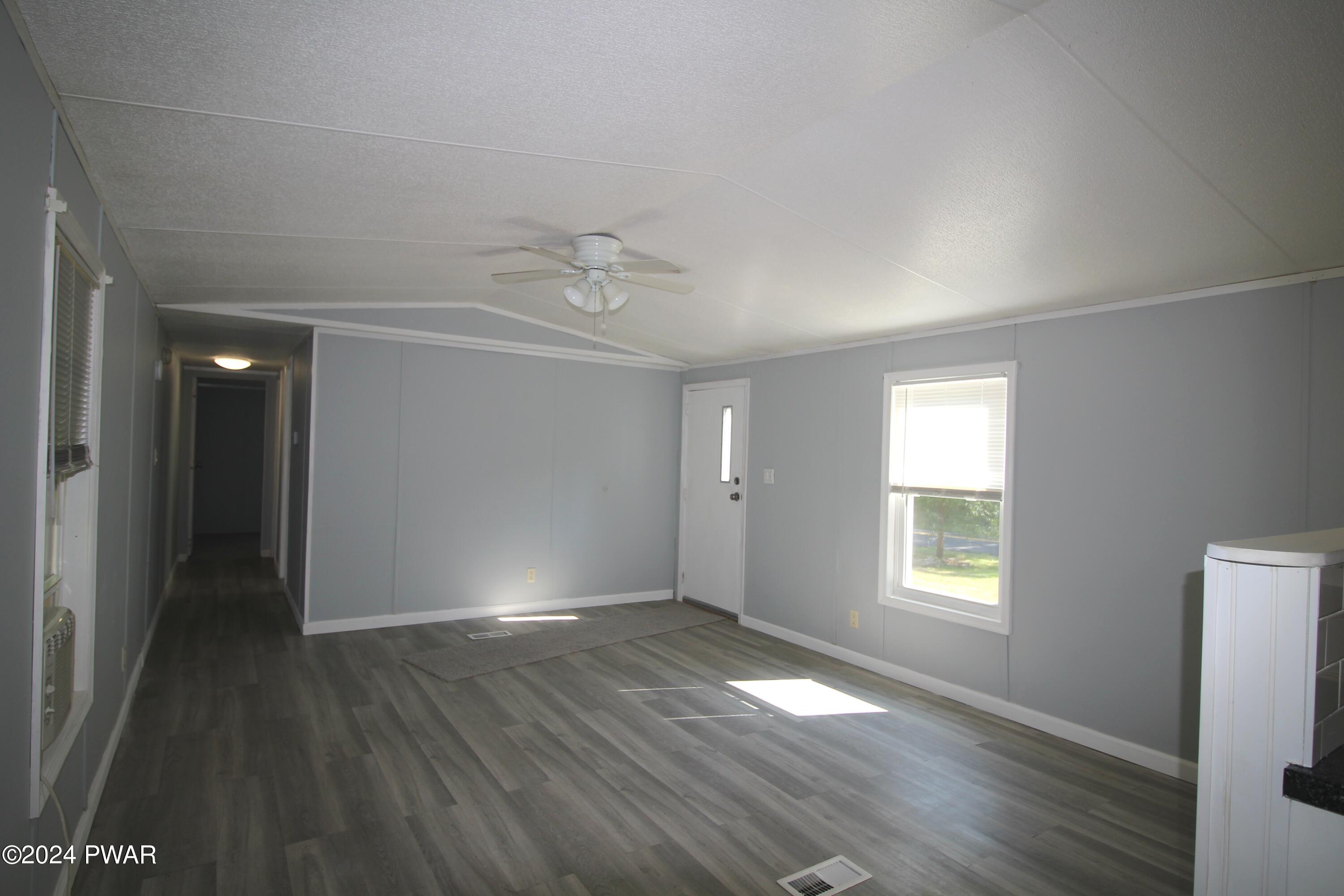 77 Pond Road Lake Ariel, PA 18436 - Photo 10 of 36 an empty room with wooden floor and windows