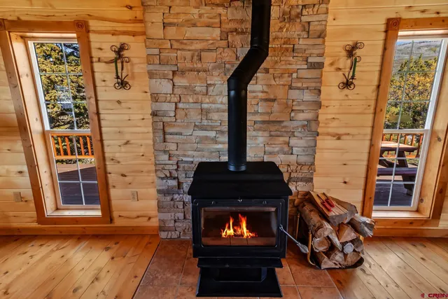 a view of a fireplace with wooden floor and a sink