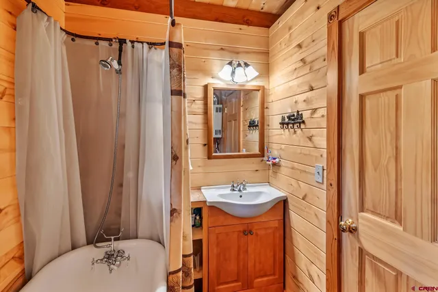 a bathroom with a sink a toilet and shower curtain